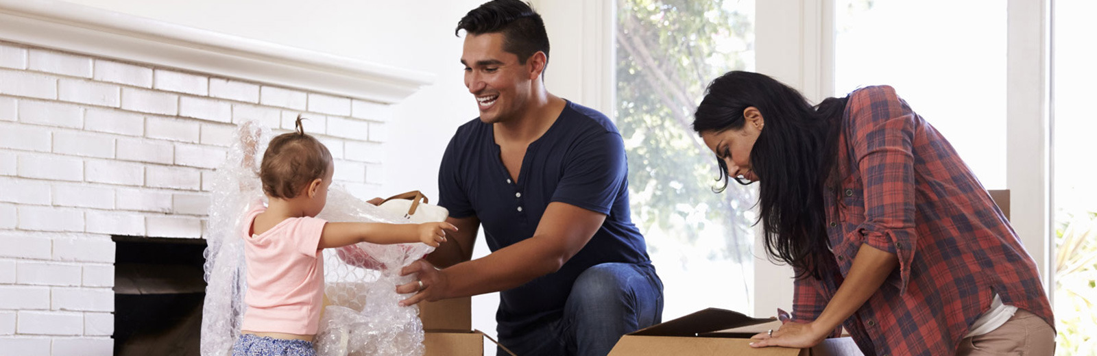 Family unpacking boxes in their new rental home